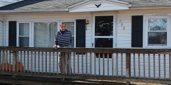 A homeowner on the front porch of her white house in Franklin County, Virginia.