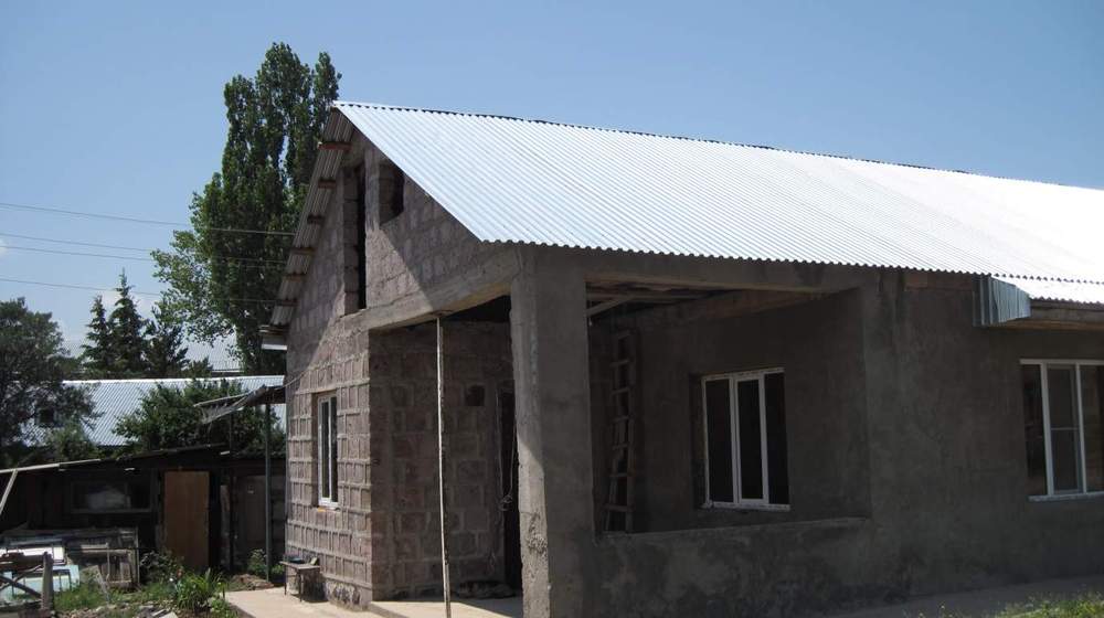 Habitat Armenia helped Nora fill out forms, obtain approval for two loans, select the building materials and supervise the construction.