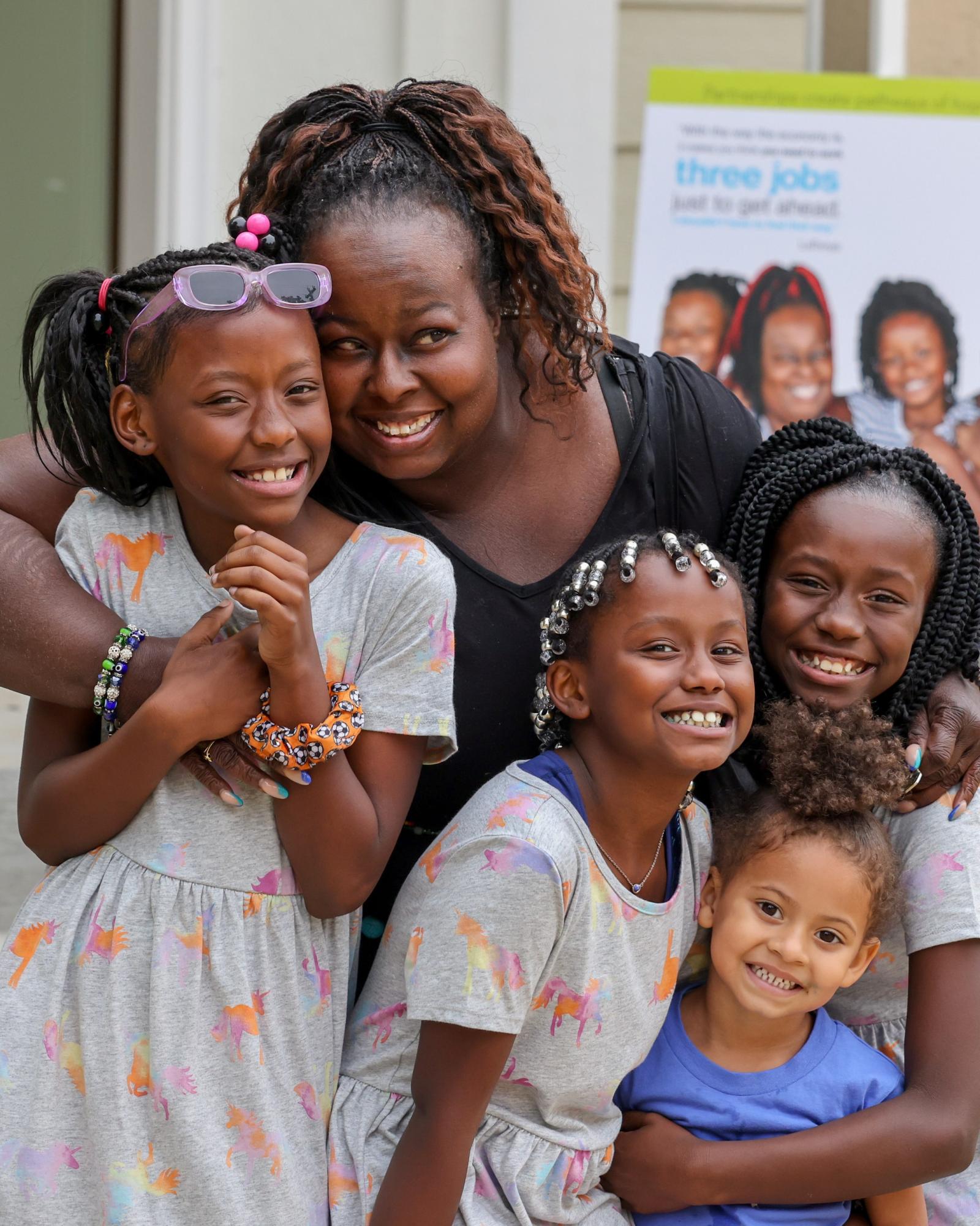 LaTonya embracing family at Habitat ceremony