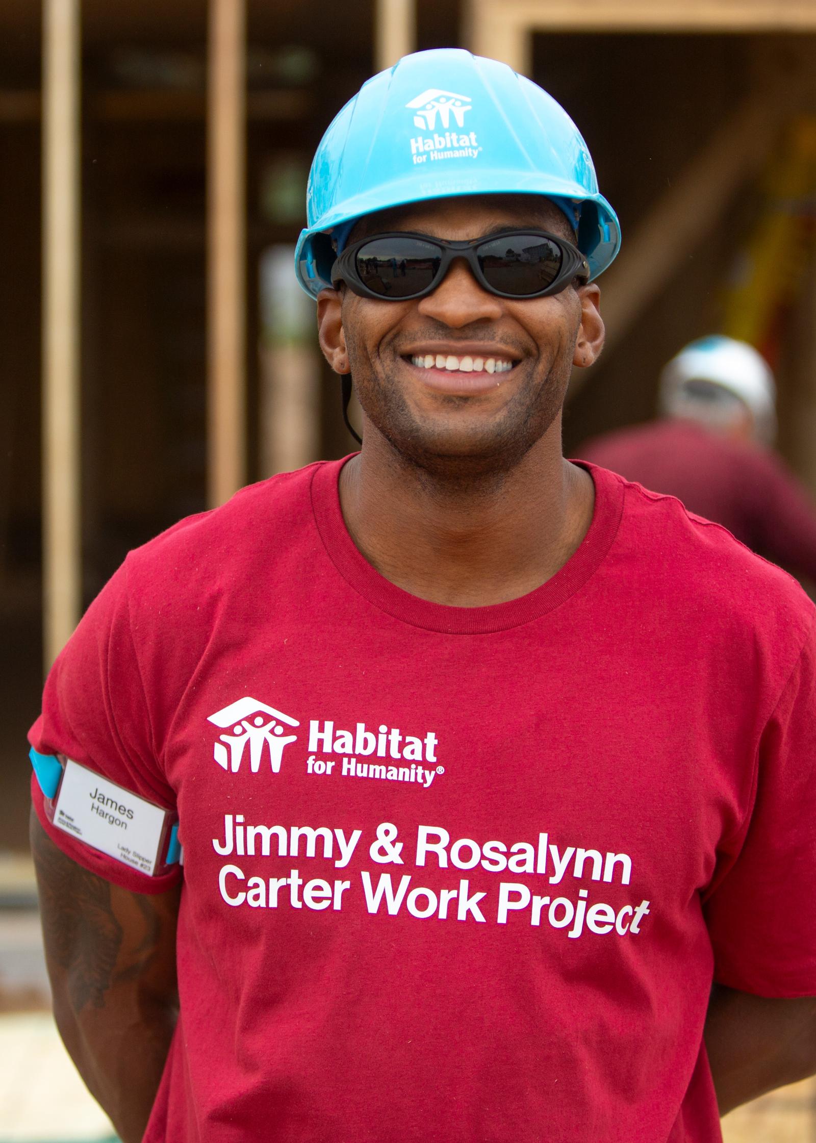 James on the buildsite smiling at the camera.