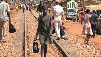 uganda-slum-girl-walking-railiways