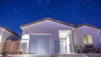 House at night against a background of stars.