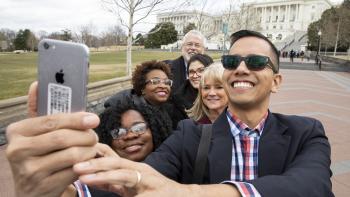 Advocates take a group selfie in front of the Capitol building in Washington, D.C.