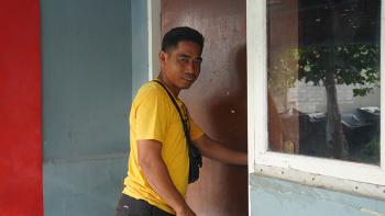 Junaedi about to enter his home in Mauk, Indonesia