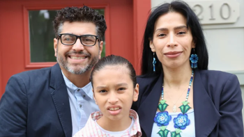 Yulisa and family standing in front of their front door. 