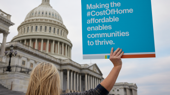 Advocate holding sign in front of U.S. Capitol