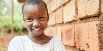 Child with brick wall