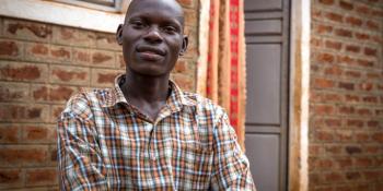 Job Kalulu in front of his home