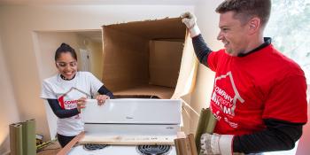 Volunteers open a donated Whirlpool range