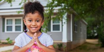 Young girl in front of a Habitat for Humanity home, Underwriters Laboratories