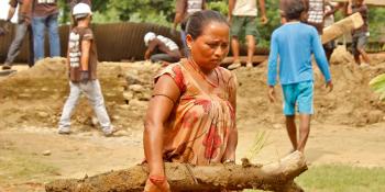 A woman helping to clear debris in flood-affected western Nepal