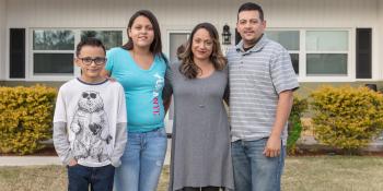 Florida family stands in front of their home. 