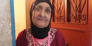 photo: face of a Lebanese woman, light is coming through door behind her 