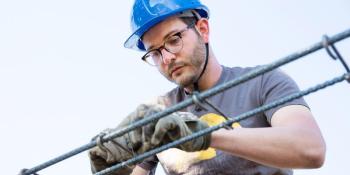 Man in hard hat on build site.