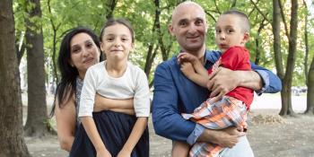 Asia and Edik holding their daughter and son.