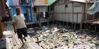 Wardi walking in an informal settlement community in north Jakarta, Indonesia