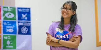 Volunteer leader Kannika Nhem smiling with arms crossed