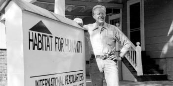 President Carter standing next to the Habitat sign