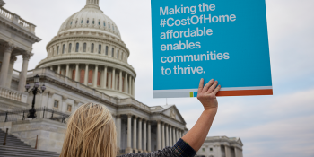 Advocate holding sign in front of U.S. Capitol