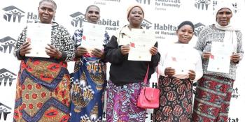 Families displaying their titles in Zambia.jpg