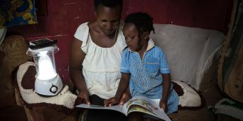 Photo: Mother and daughter reading a book together, Uganda