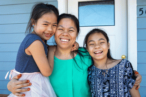 Minh Nguyen and her daughters, Nhu Ngan ‘Kiki’, 11, and Nhu-Y ‘Candy’, 7, in front of their future Habitat home.