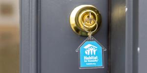 key in lock with blue Habitat keychain