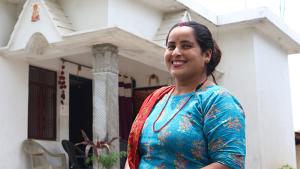 Laxmi, a former bonded laborer, in front of her home in western Nepal