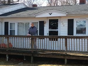 A homeowner on the front porch of her white house in Franklin County, Virginia.