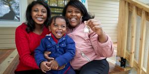 Jessica hugging her two children on their porch.