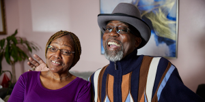 Regina and Larry in their home with big smiles