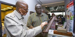 Two men look at prototype at ShelterTech Kenya accelerator.