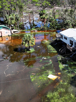 Aerial view of homes submerged in flood waters.