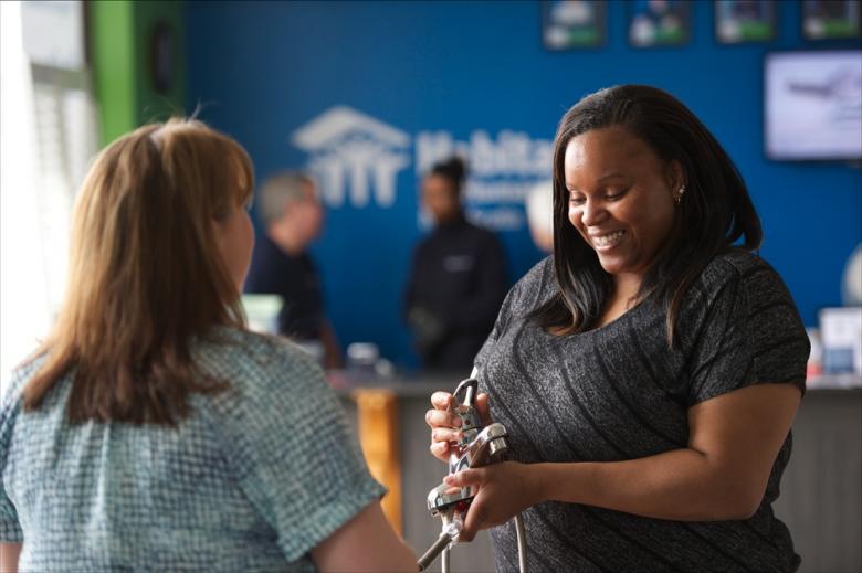 Habitat homeowner Yvette (right), who volunteered at a ReStore for sweat equity.