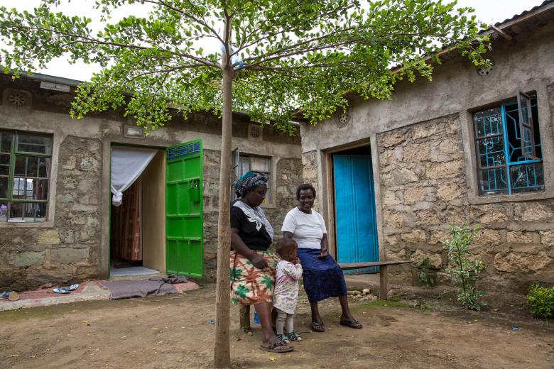 Jane with her family in front of their new house