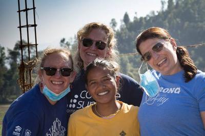 Nepali female mason Sharada (center) with international volunteers