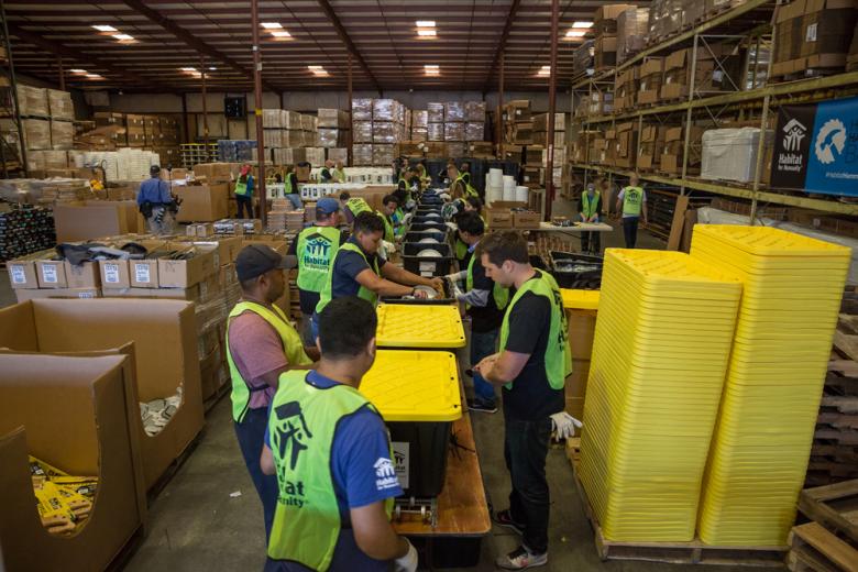 Habitat volunteers assemble shelter repair kits