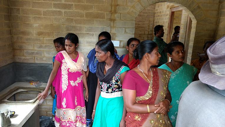 Local community members visiting the first house built with compressed stabilized earth blocks in Habitat's EU-funded project