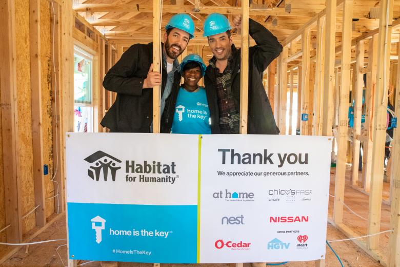 Drew and Jonathan Scott with future Habitat homeowner Krushetta on build site.