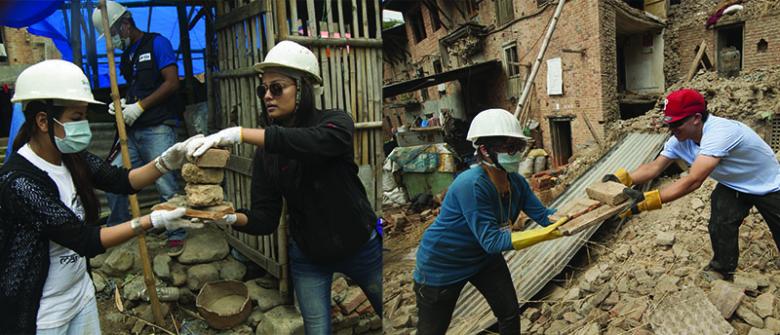 Youth volunteers help clear rubble.