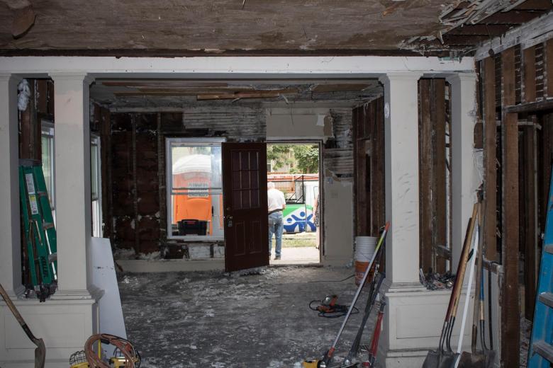 A room that's been gutted down to framing and concrete floors.