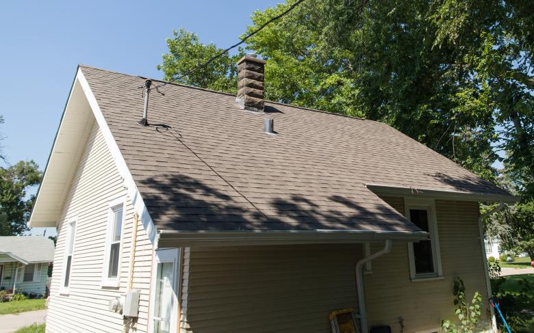 Same one-story house with new roof and fresh paint.