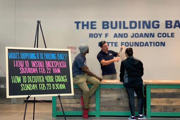 The front desk of the Autsin ReStore with a blackboard that reads, "What's happening at the building bar? How to install backsplash. How to declutter your garage."