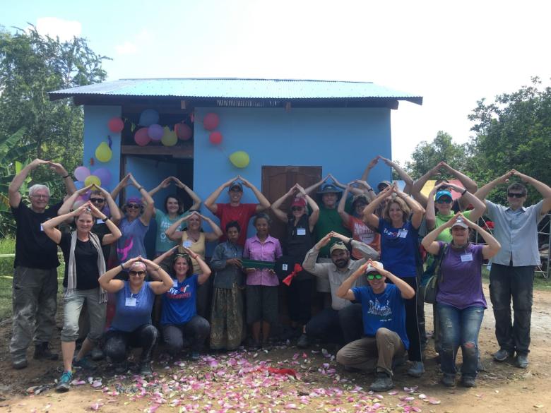 Anne Lowrance posing with volunteers on Habitat build site