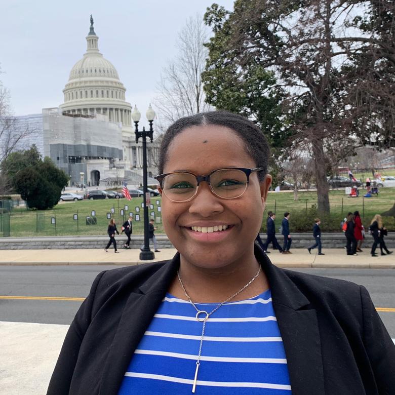 Kirby smiling in Washington, D.C., with capitol building in the background