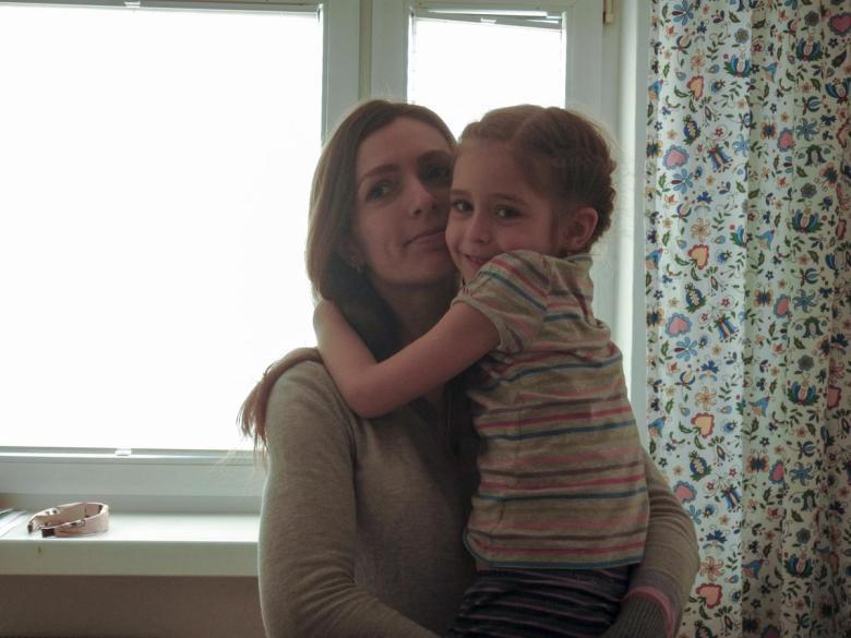 Mother holding young girl.