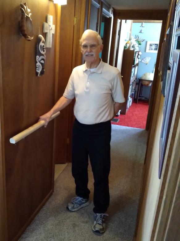 Homeowner Bryant Farr standing in hallway next to hand rail installed by Habitat