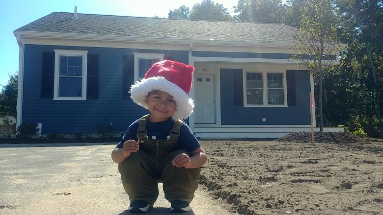 Boy sitting in front of home