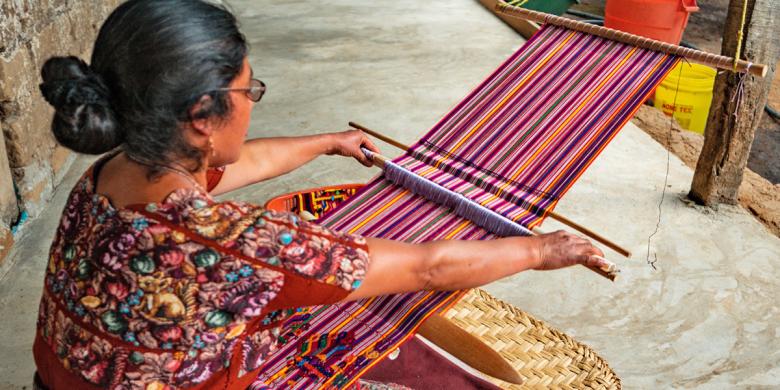 María Natalia weaves on her concrete floor. ©Habitat for Humanity Guatemala/José Ramírez.