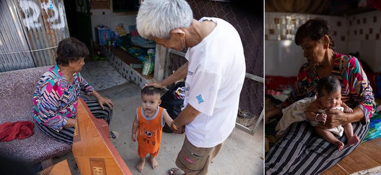 Sreang (center) and his wife Vanna look after their grandchildren